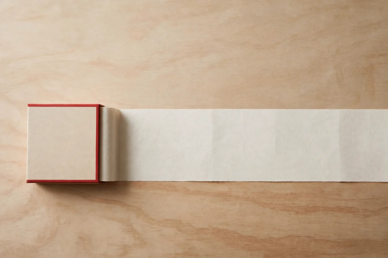 Illustration: a long blank paper ribbon unrolls from a compact box and stretches out of frame, evoking a long context window in an open language model.