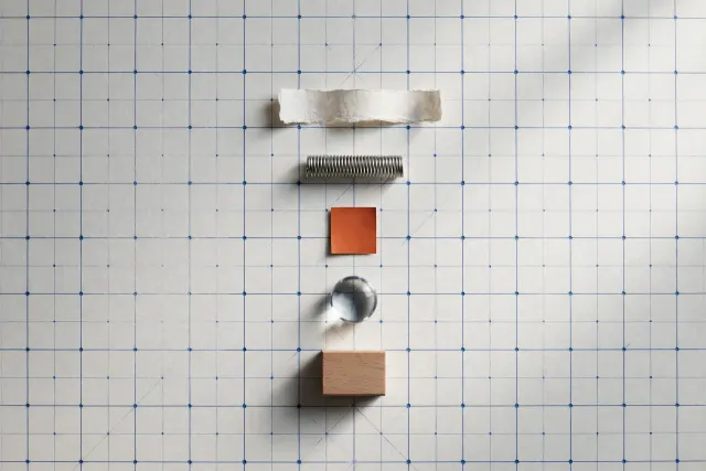 Five different materials — paper, metal, color, glass and wood — placed on a coordinate grid, illustrating a shared embedding model for text, code, image, video and audio.