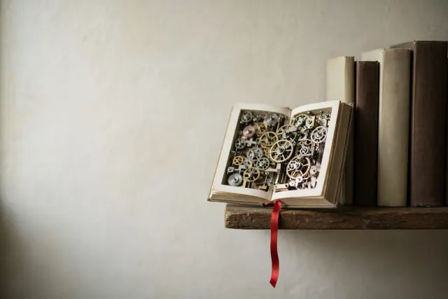 Illustration of an opened hardcover book with clockwork gears where pages should be, surrounded by plain books on a shelf — evoking hidden machine-generated production in the publishing industry.