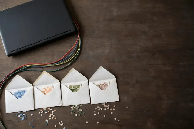 Illustration: a dark laptop with cables carrying small pixelated image fragments into open envelopes, visualizing how an AI agent accidentally exposed internal screenshots.