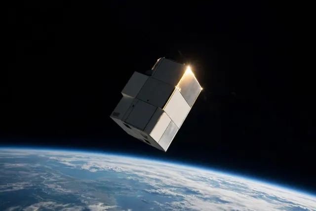 Illustration: A refrigerator-sized satellite in low Earth orbit, with the planet's curved horizon below and a sharp glint of sunlight on its metal edge.