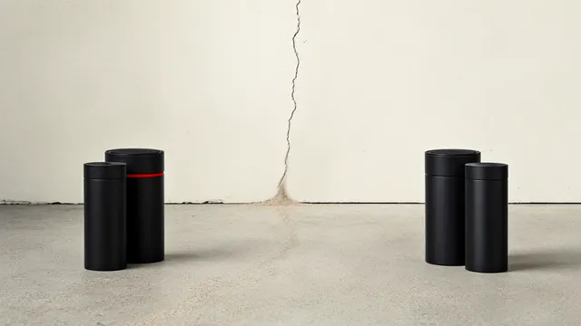 Illustration: three black canisters separated from a sealed wall with a hairline crack leaking sand, symbolizing the leak of confidential information.