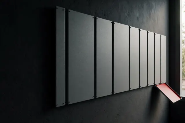 Illustration: a long row of identical gray safety panels on a dark wall, one panel detaching and tilting outward with a red underside.