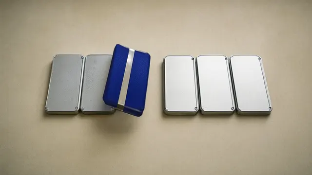 Illustration: six matte metal modules in a row on paper, one cobalt-blue module shifted out of alignment, soft shadows and generous negative space.